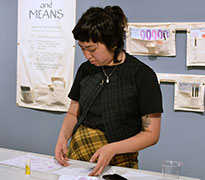 A participant prepares a gratitude letter. Participants are invited to interact with all activity kits and garments.