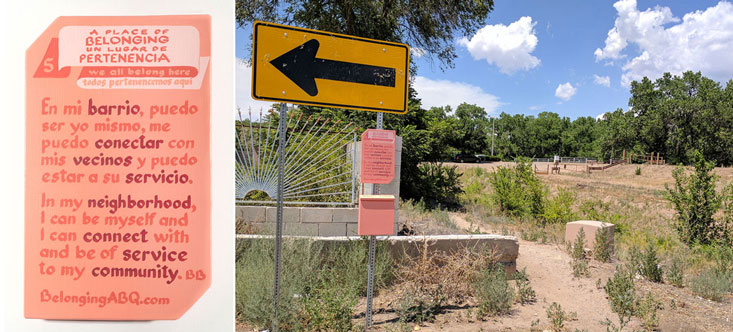 image of a belonging sign at the head of a desire trail to th middle rio grande. Text of the sign: A Place of Belonging #5. we all belong here. In my neighborhood I can be myself and I can connect with and be of service to my community. BB. Un lugar de pernenencia. todos pertenencemos aquí. En mi barrio, puedo ser yo mismo, me puedo conectar con mis vecinos y puedo estar a su servicio.t BelongingABQ.com