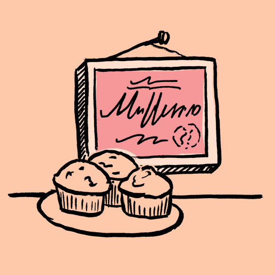 a framed certificate hanging on a wall abovea dish of muffins