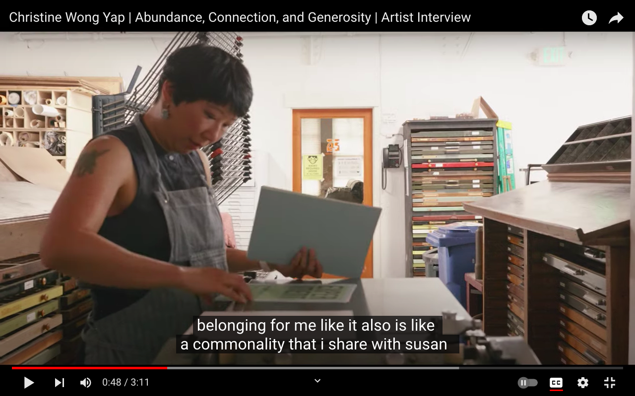Video still of the artist working at a leterpress