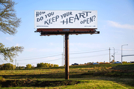 billboard above a field, with the text: How do you keep you heart open, written in calligraphy