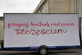 the artwork printed as a mobile billboard (wagon) in a city street