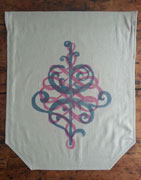 a nuetral colored banner with beveled corners on the bottom. it is overprinted with a pink swirling calligraphic flourish and a blue floral ornamental design.