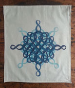 a rectangular, neutral colored banner. it is overprinted with the swirling calligraphic design, in different orientations and shades of blue, to make a symmetrical 8-pointed shape.