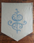 a neutral-colored banner with the bottom cut like a triangle. it is printed with a single floral design in blue. 