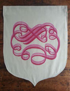 a neutral-colored banner with the bottom half sewn in an onion shape. it is overprinted with a cloud-like calligraphic flourish in hot pink and pink. the design is offset slightly as if to create a drop shadow effect.