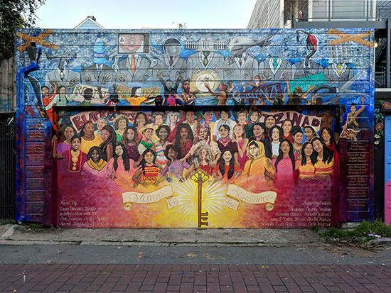 mural of many women painted on a garage door