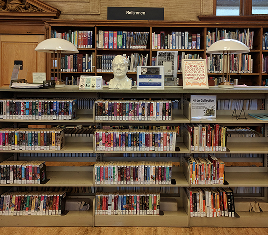 a view of library book shelves with a certificate on top.