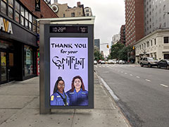 'thank you for your commitment' artwork in digital screen in a bus shelter