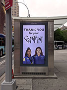 'thank you for your commitment' artwork in digital screen on a newsstand