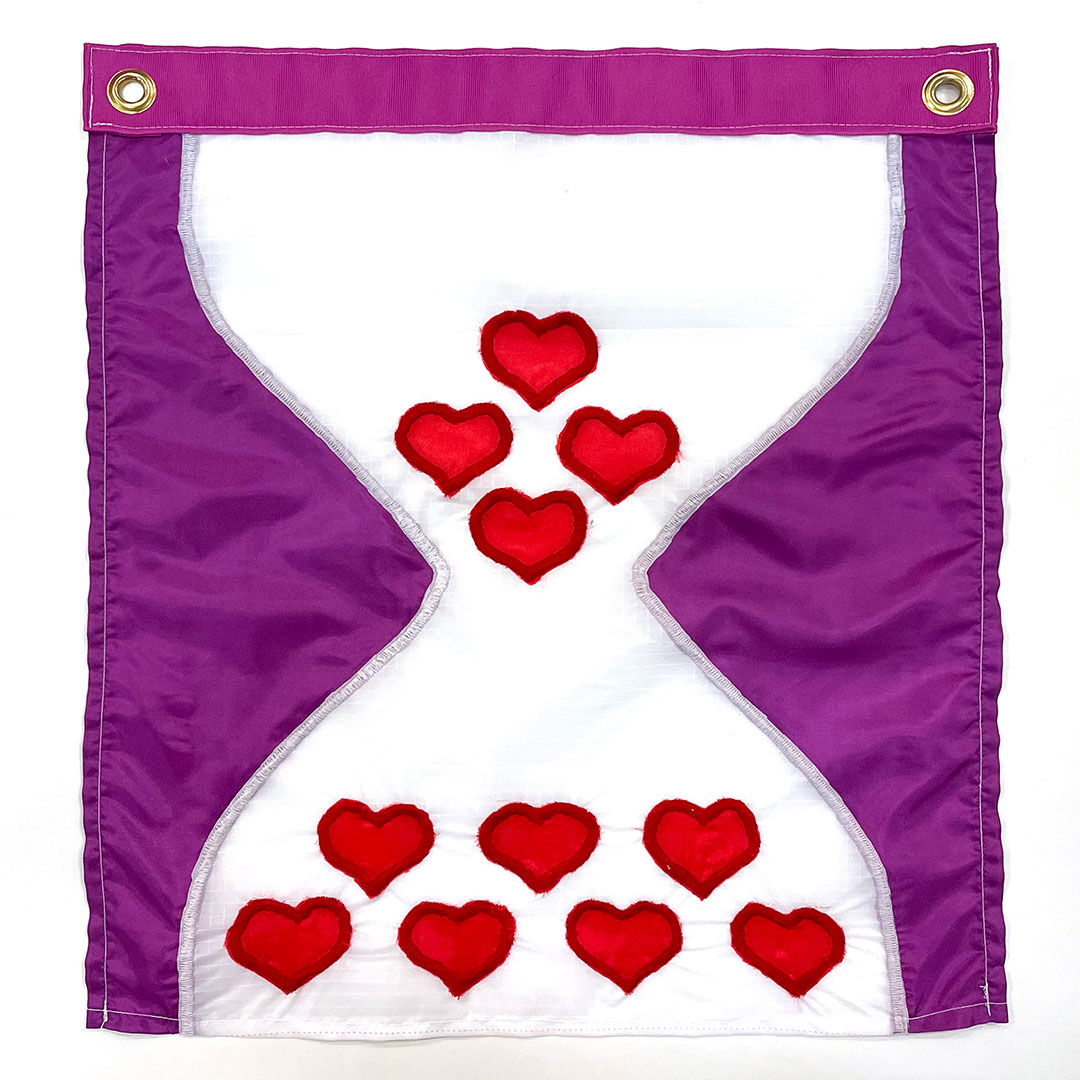 sewn flag of a white hourglass shape appears on a purple background. Within the hourglass are red hearts.