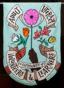 Banner for Adult Literacy services, with text, A community of Learners and volunteers with a bouquet and hands