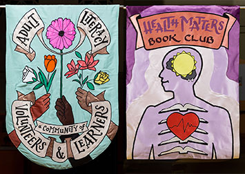 Adult Literacy banner with many hands holding a bouquet of flowers with the text, A community of learners and volunteers
