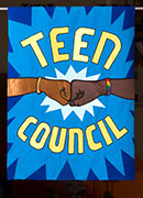 Banner in blue and yellow with two fists bumping