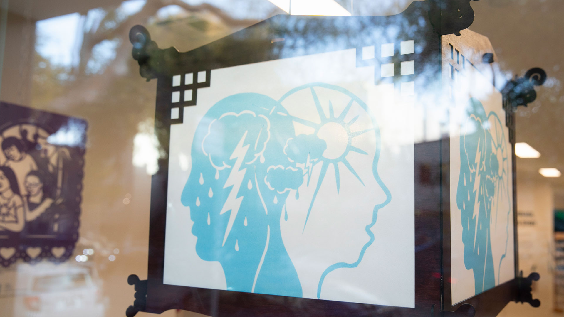 a photo of a lantern about mental health in a window.